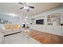 Bright living room featuring a large built-in entertainment center and hardwood floors at 106 Oakview Psge, Canton, GA 30114