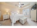 Serene main bedroom with tray ceilings, carpet floors, and bright natural light at 106 Oakview Psge, Canton, GA 30114