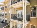 A private balcony featuring neutral stucco siding, white trim, and black metal railing at 799 Hammond Dr # 305, Atlanta, GA 30328