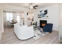 Open-concept living room with fireplace, light grey floors, and eat-in kitchen provides a relaxed and modern atmosphere at 1587 Aiden Way # 43, Conyers, GA 30013