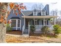 Charming home with a covered porch and a bay window adding character to the front exterior at 1931 Amber Dawn Way, Lawrenceville, GA 30043