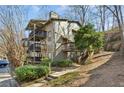Multi-level condo building with private balconies and stairs leading to the landscaped grounds at 2701 Cumberland Se Ct, Smyrna, GA 30080