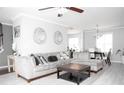 Spacious living room featuring a comfortable gray sectional sofa, a plush rug and a modern decor that adds style at 5895 Water Oaks Dr, Austell, GA 30106