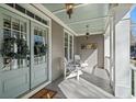 Cozy front porch featuring double doors, hanging lanterns, and seating at 4465 Newhall Dr, Cumming, GA 30040