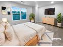 Serene staged bedroom with large windows, plush carpet, and modern furniture at 1112 Highwood Ln, Atlanta, GA 30344