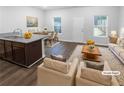 Bright, open-concept living room and kitchen with modern furnishings and hardwood style floors at 1112 Highwood Ln, Atlanta, GA 30344