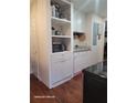 Efficient kitchen space with white cabinetry, appliances, and laminate wood flooring at 2335 Boulder Se Rd, Atlanta, GA 30316