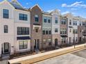 View of townhomes featuring a brick and siding facade, black trim, and an accessible sidewalk at 355 Walker Avenue, Roswell, GA 30076