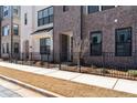 Attractive townhome exterior with brick facade, black accents, and fresh landscaping at 355 Walker Avenue, Roswell, GA 30076