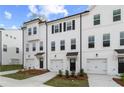 Picture of attractive townhomes with white siding, black accents, and well-maintained landscaping at 3162 Washburn Sw St, Atlanta, GA 30354