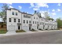 New townhome construction boasts white exteriors and convenient attached garages along quiet street at 3162 Washburn Sw St, Atlanta, GA 30354