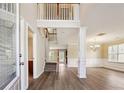 Grand foyer featuring hardwood floors, wainscoting and an open staircase at 1309 Avington Glen Dr, Lawrenceville, GA 30045