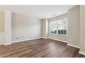 Bright living room with hardwood floors, large windows, and classic trim details at 1309 Avington Glen Dr, Lawrenceville, GA 30045