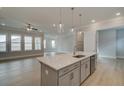 Open-concept kitchen with stainless steel appliances and a large island with a sink at 7220 Winderlea Ln, Cumming, GA 30040