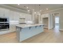 Spacious kitchen with stainless steel appliances, white cabinets and a gray kitchen island at 7220 Winderlea Ln, Cumming, GA 30040