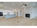 Open concept living area with a modern kitchen and a fireplace with a mantel at 7220 Winderlea Ln, Cumming, GA 30040