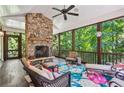 Inviting screened porch with a stone fireplace and comfortable seating, perfect for relaxing at 1762 Nancy Creek Bluff, Atlanta, GA 30305