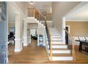 Inviting foyer with hardwood floors, a staircase with iron balusters, and views into other living spaces at 416 Telfair Way, Canton, GA 30115