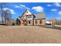 Expansive front yard with a two-story brick home with an attached garage at 416 Telfair Way, Canton, GA 30115