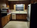 Kitchen featuring stainless steel refrigerator and plentiful wooden cabinets at 5535 Beaver Sw Dr, Mableton, GA 30126