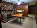Cozy living room showcases a stone fireplace and wood-paneled walls at 5535 Beaver Sw Dr, Mableton, GA 30126