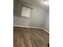 This bedroom features hardwood flooring and a window for natural lighting at 5690 Deerfield Ct, College Park, GA 30349