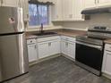 Modern kitchen with stainless steel appliances, sleek countertops, and ample cabinet space at 5690 Deerfield Ct, College Park, GA 30349