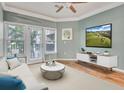 Cozy living room with neutral tones, balcony access, and a modern entertainment setup at 1850 Cotillion Dr # 3305, Atlanta, GA 30338