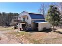 Large barn featuring a covered parking area, upstairs living space, and staircase at 1370 Cronic Town Rd, Auburn, GA 30011