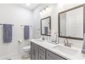 Bright bathroom featuring double sinks, gray cabinets, and modern fixtures at 2700 Pine Tree Ne Rd # 2201, Atlanta, GA 30324