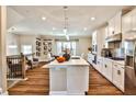 Modern kitchen featuring a large island, white cabinets, stainless steel appliances, and hardwood floors at 429 Stagecoach Bnd, Smyrna, GA 30080