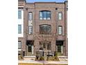 Brick exterior elevation of a two-story home with a small front yard and a tree at 726 Edgewood Ne Ave, Atlanta, GA 30307