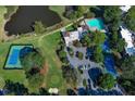 Aerial view showcasing tennis courts, a pond, and a community clubhouse with a pool at 80 Adrian Pl, Atlanta, GA 30327