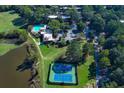 Wide aerial shot showing community features including a golf green, pool, and tennis courts at 80 Adrian Pl, Atlanta, GA 30327