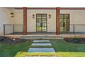 Inviting covered porch with wooden columns, stone walkway, and stylish sconces at 819 Loridans Ne Dr, Atlanta, GA 30342