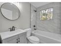 Updated bathroom features modern fixtures and stylish tile work around the tub at 556 Holly Nw St, Atlanta, GA 30318