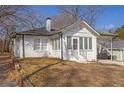 Charming bungalow showcasing a painted brick facade, carport, and tidy front yard at 556 Holly Nw St, Atlanta, GA 30318