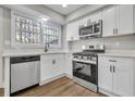 Bright kitchen featuring white cabinetry, quartz countertops, and stainless steel appliances at 556 Holly Nw St, Atlanta, GA 30318