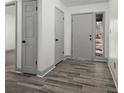 Inviting entryway with wood-look floors, neutral paint, and ample closet space at 7256 Attache Way, Riverdale, GA 30296