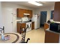 Cozy kitchen with white appliances, a window, and wood cabinets at 1195 Stony Pt, Grayson, GA 30017