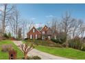 Beautiful two-story brick home with manicured front lawn and a long driveway at 3620 Highpoint Rd, Cumming, GA 30041