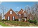 Attractive two-story brick home with black shutters and large front yard at 3620 Highpoint Rd, Cumming, GA 30041