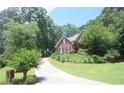 Beautiful two-story brick home with well-manicured lawn and inviting driveway at 3620 Highpoint Rd, Cumming, GA 30041