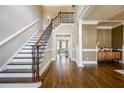 Spacious foyer with hardwood floors, staircase, and a glimpse into the living room at 5029 Tarry Glen Dr, Suwanee, GA 30024