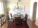 Traditional dining room with a wooden table, seating for six and stylish chandelier at 207 Birchwood Dr, Loganville, GA 30052