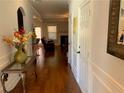 Inviting hallway featuring gleaming hardwood floors and decorative accents at 207 Birchwood Dr, Loganville, GA 30052