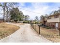 The long, private driveway leads to this charming home with a fenced-in yard at 7121 Forest Se Dr, Covington, GA 30014