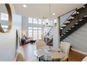 Charming dining room with a glass table, staircase, modern light fixture, and hardwood flooring at 1253 Caroline Ne St, Atlanta, GA 30307