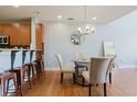 Open-concept dining space with a glass table, adjacent kitchen bar, and stainless steel appliances at 1253 Caroline Ne St, Atlanta, GA 30307