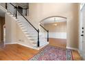Elegant foyer with hardwood floors, staircase, and traditional decor at 514 Lovinggood Ct, Woodstock, GA 30189